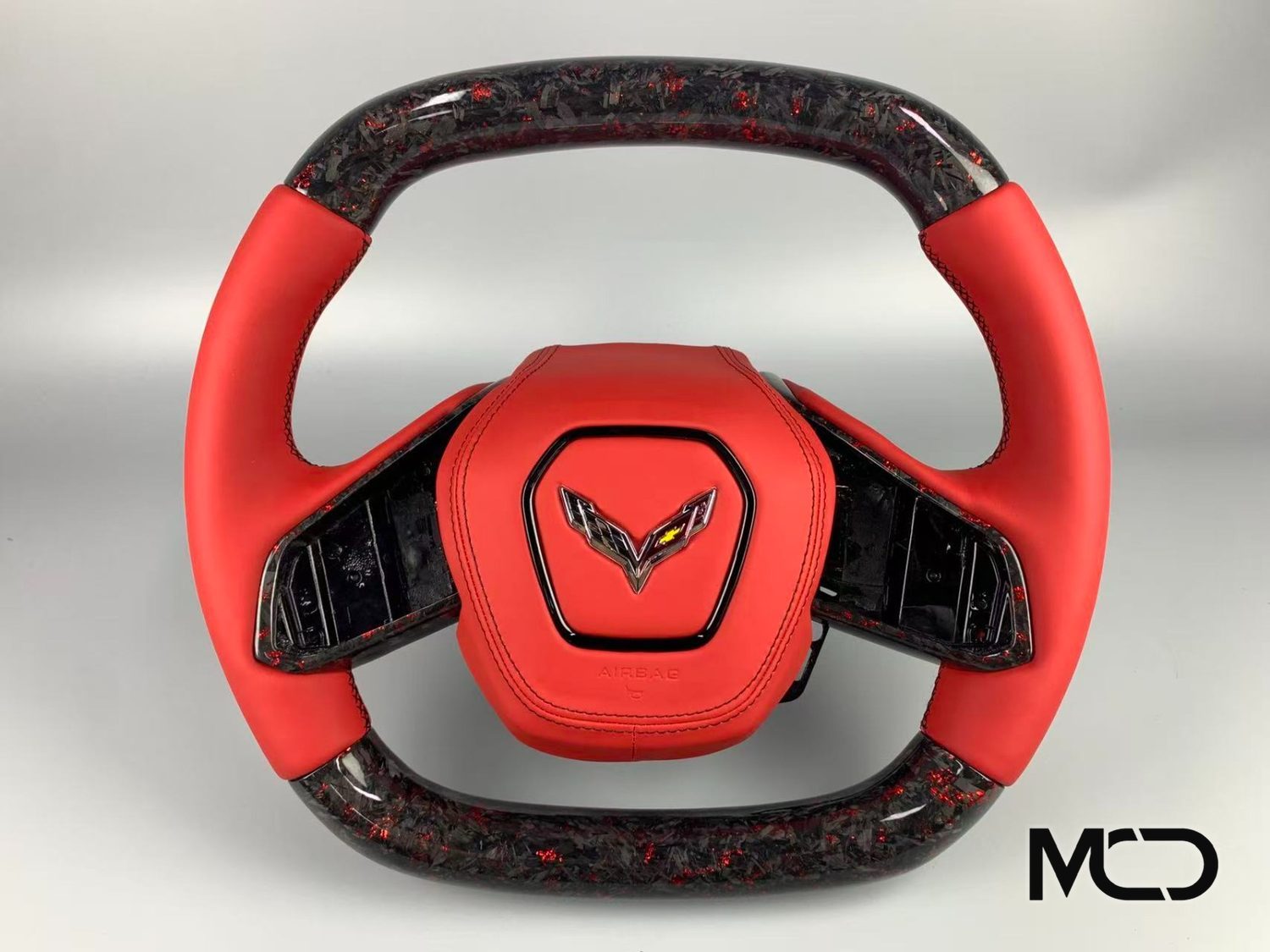 Corvette C8 steering wheel in red leather with forged carbon fiber and red flakes by Miami Carbon Designs