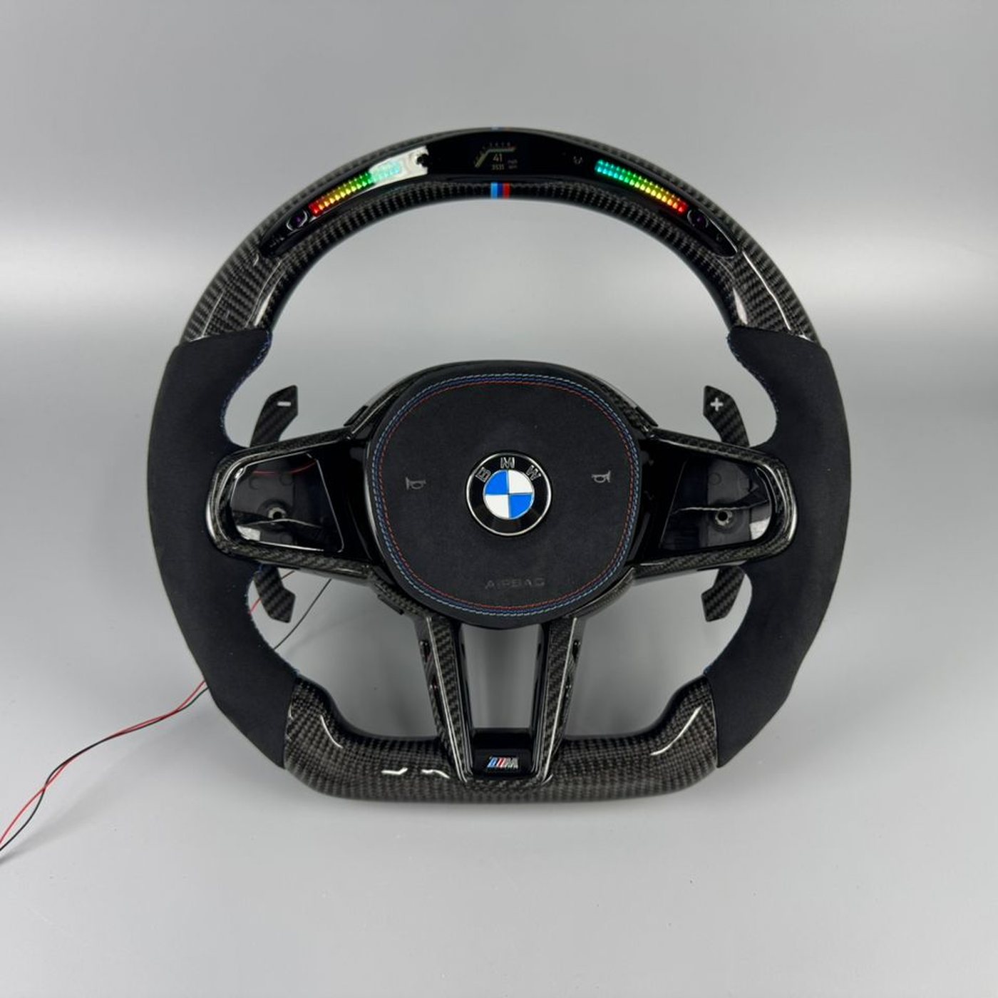 BMW G series custom gloss carbon fiber steering wheel with black Alcantara, LED display and M tricolor stripe by Miami Carbon Designs