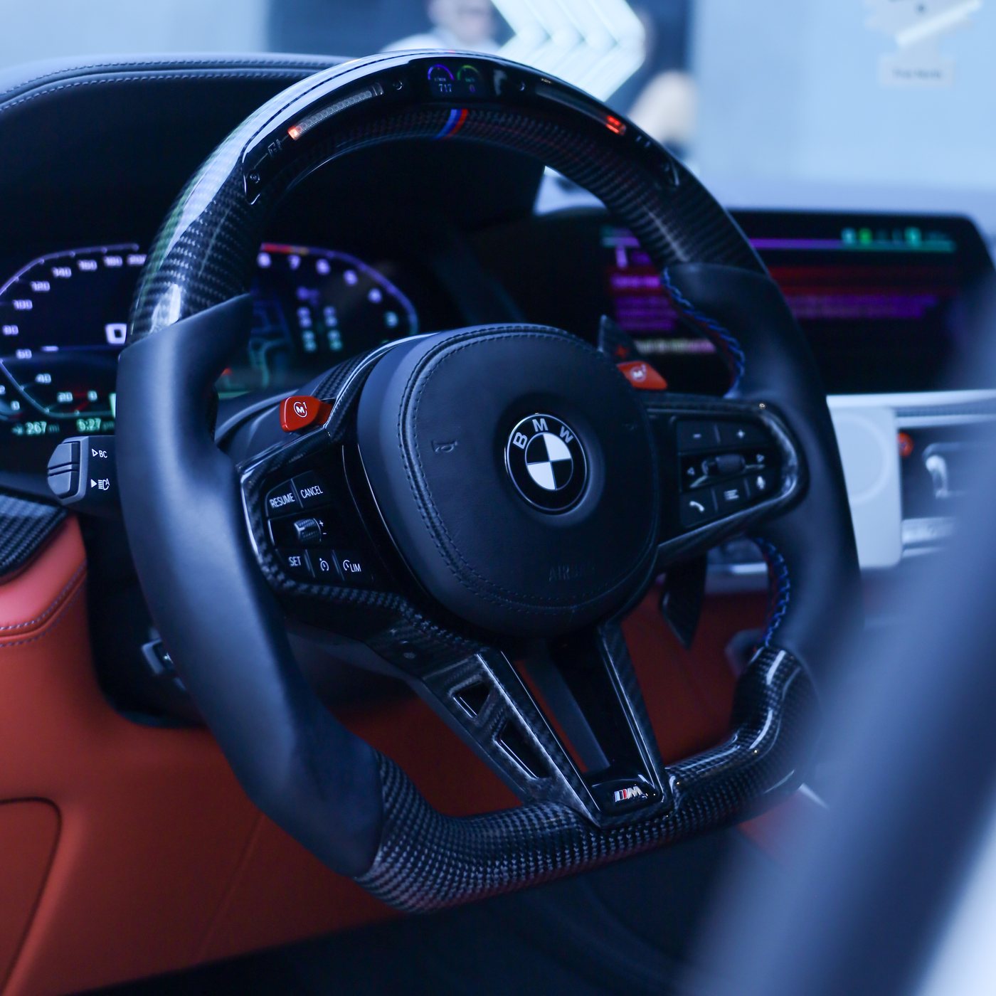 BMW G series custom carbon fiber steering wheel in black leather with LED display and M tricolor stripe, installed, by Miami Carbon Designs