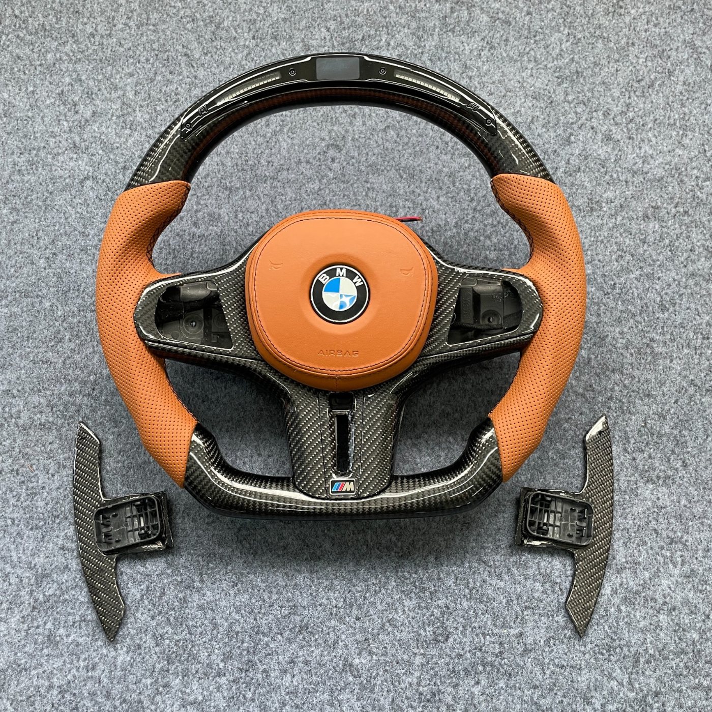 BMW G series custom carbon fiber steering wheel in cognac perforated leather with LED display and carbon paddles by Miami Carbon Designs