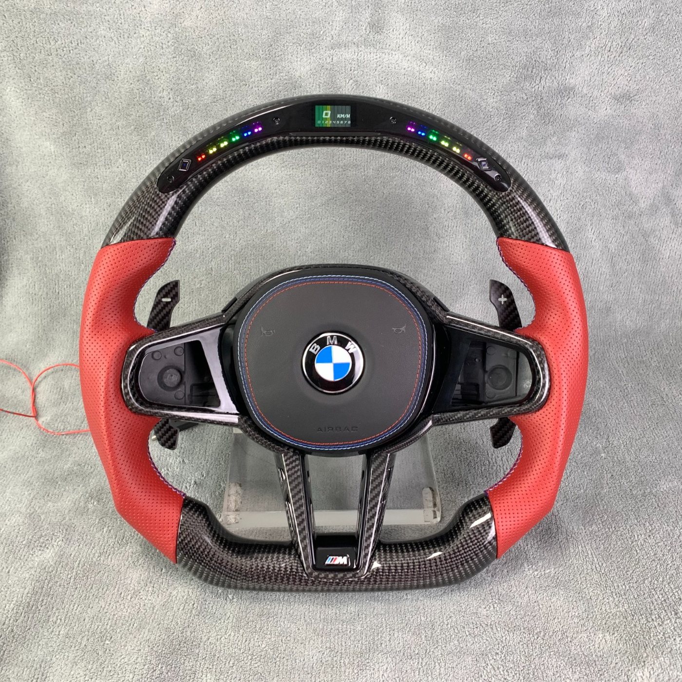 BMW G series custom gloss carbon fiber steering wheel in red perforated leather with LED display by Miami Carbon Designs