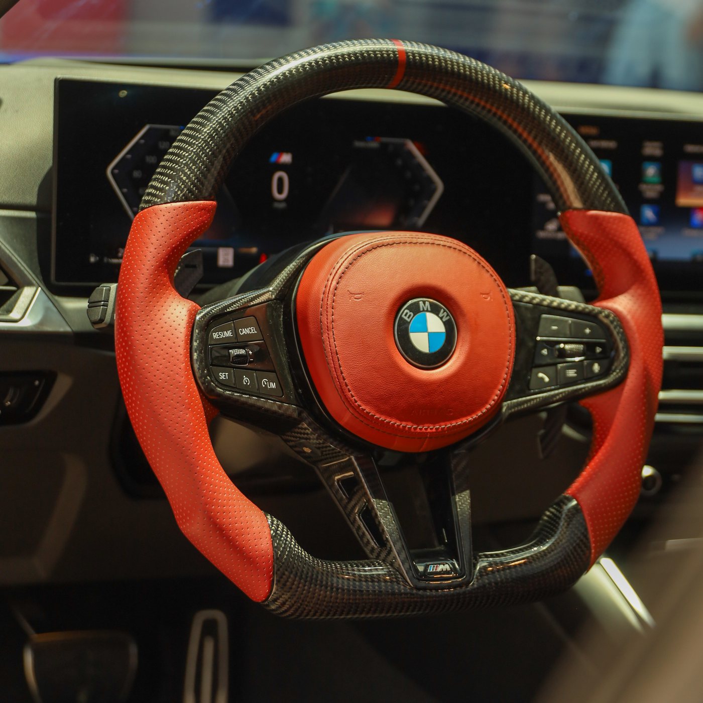 BMW G series custom carbon fiber steering wheel in red perforated leather with red centerline and red airbag cover, installed, by Miami Carbon Designs