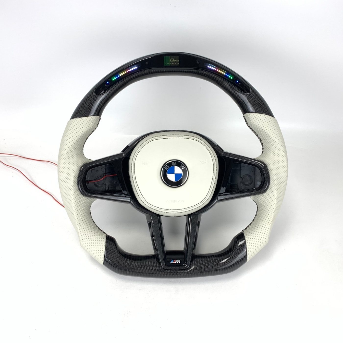 BMW G series custom gloss carbon fiber steering wheel in white perforated leather with LED display by Miami Carbon Designs