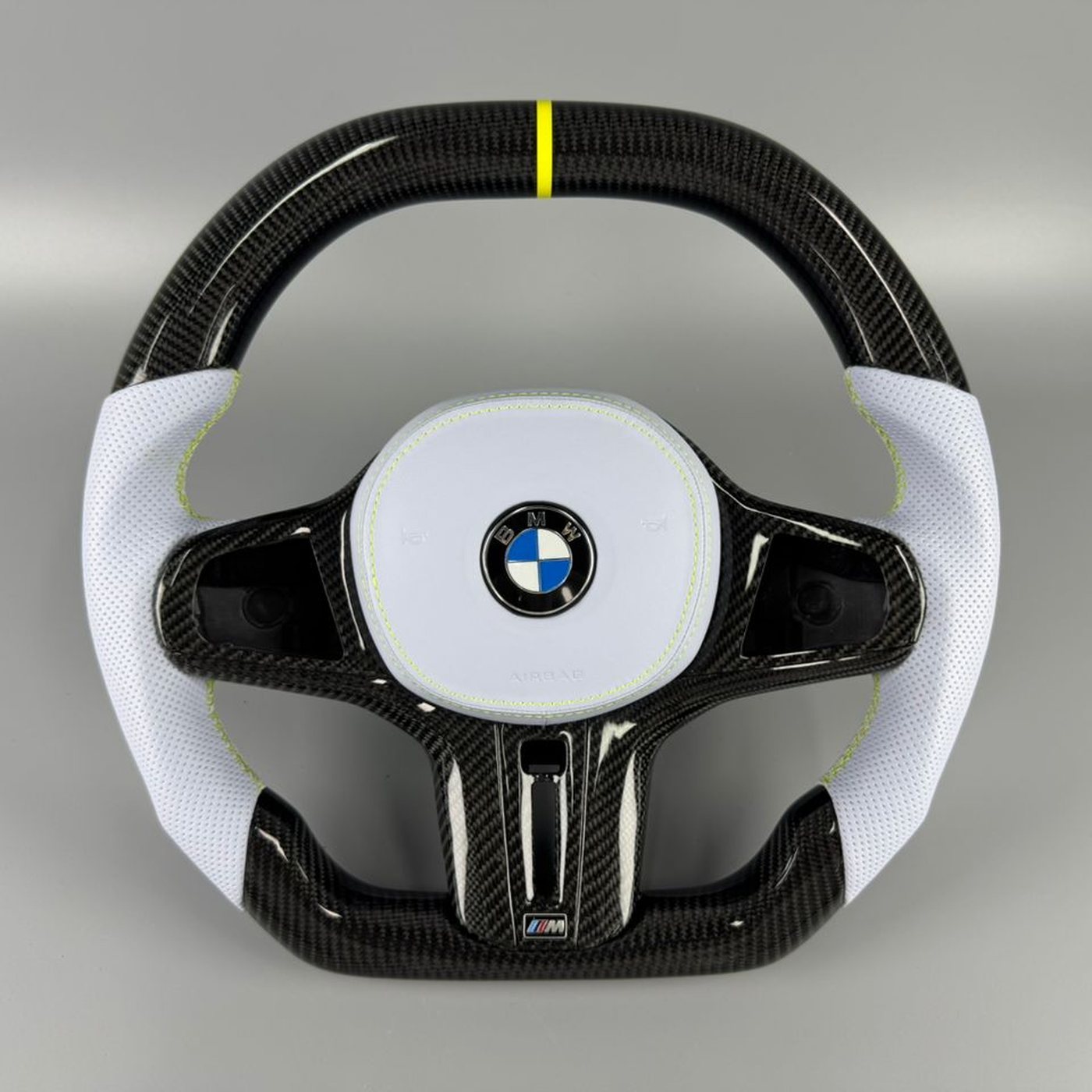 BMW G series custom gloss carbon fiber steering wheel with white perforated leather, yellow centerline and yellow stitching by Miami Carbon Designs