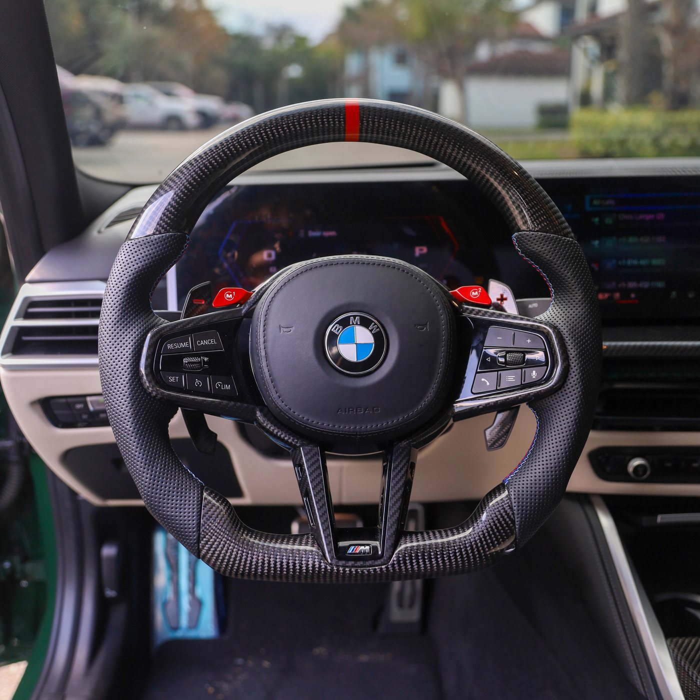 BMW G80 M3 custom carbon fiber steering wheel in black perforated leather with red centerline, installed, by Miami Carbon Designs