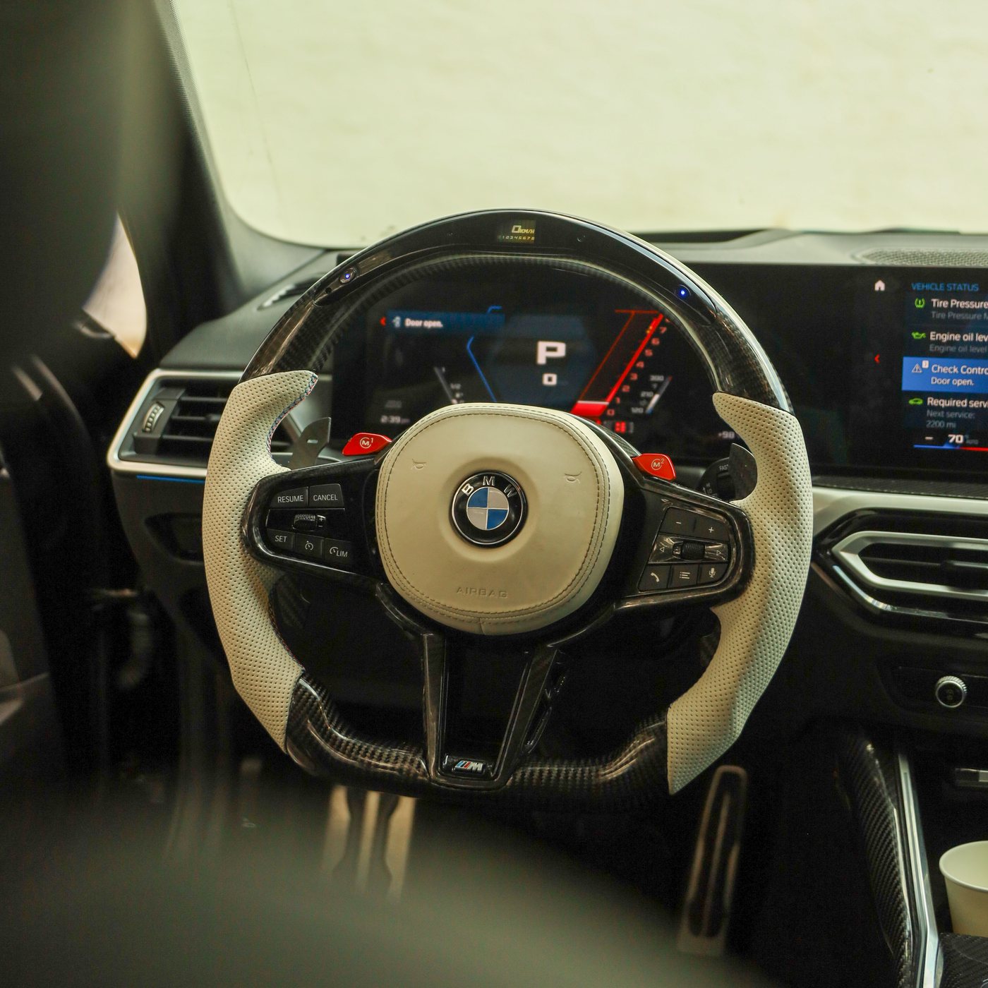 BMW G80 M3 custom carbon fiber steering wheel in white perforated leather with LED display, installed, by Miami Carbon Designs
