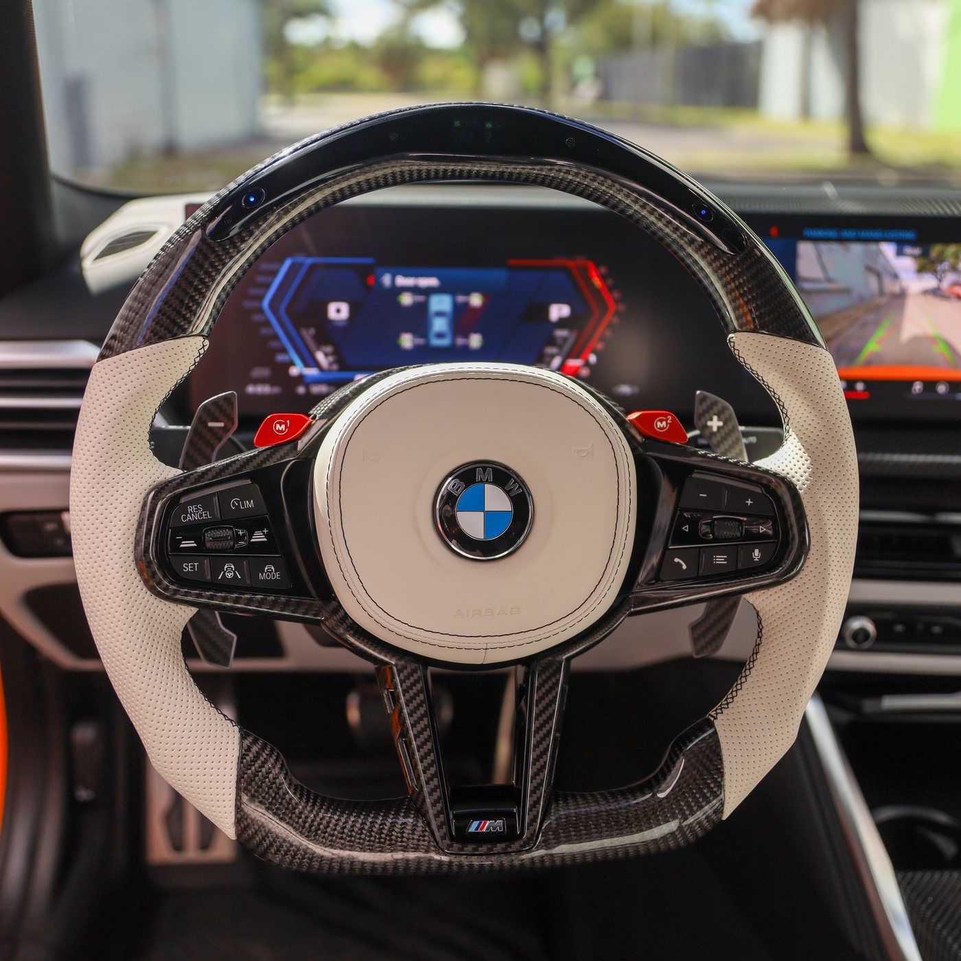 BMW G82 M4 custom carbon fiber steering wheel in white perforated leather with LED display and carbon paddles, installed, by Miami Carbon Designs
