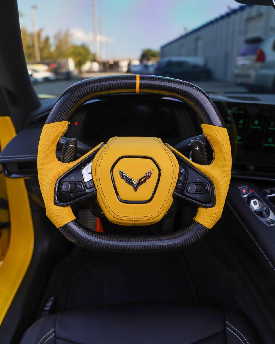 Custom carbon fiber steering wheel in yellow leather installed in a Corvette C8