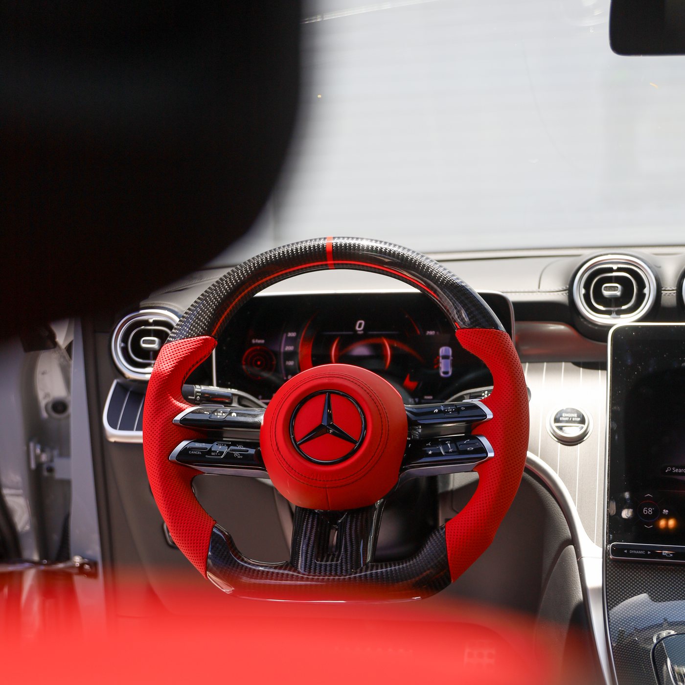 Mercedes 2024 GLC custom carbon fiber steering wheel in red perforated leather with red centerline and red airbag cover, installed, by Miami Carbon Designs