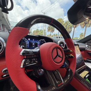 Mercedes AMG SL custom carbon fiber steering wheel in red perforated leather with red centerline, installed, by Miami Carbon Designs