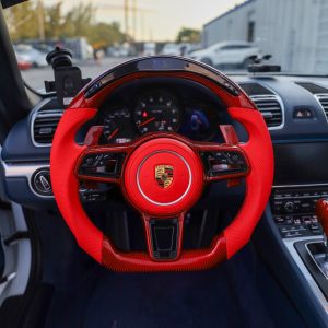 Porsche 718 Boxster custom steering wheel in red perforated leather and red carbon fiber with LED shift display, installed, by Miami Carbon Designs
