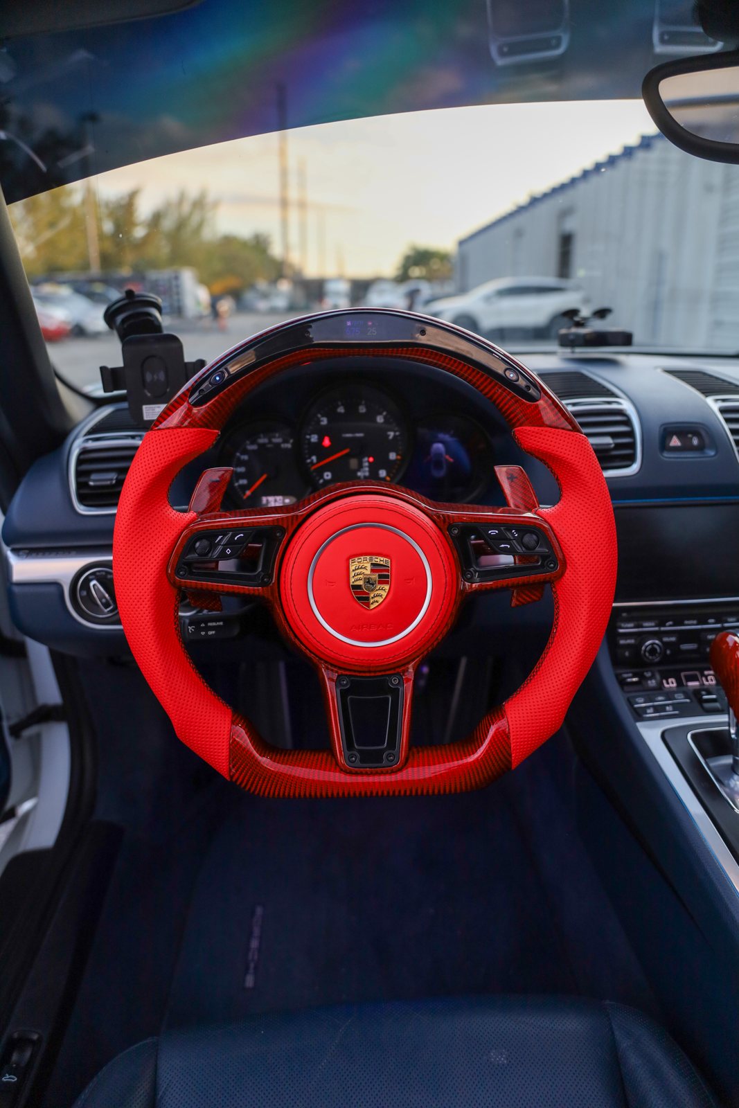 Porsche 718 Boxster custom steering wheel in red perforated leather and red carbon fiber with LED shift display, installed, by Miami Carbon Designs