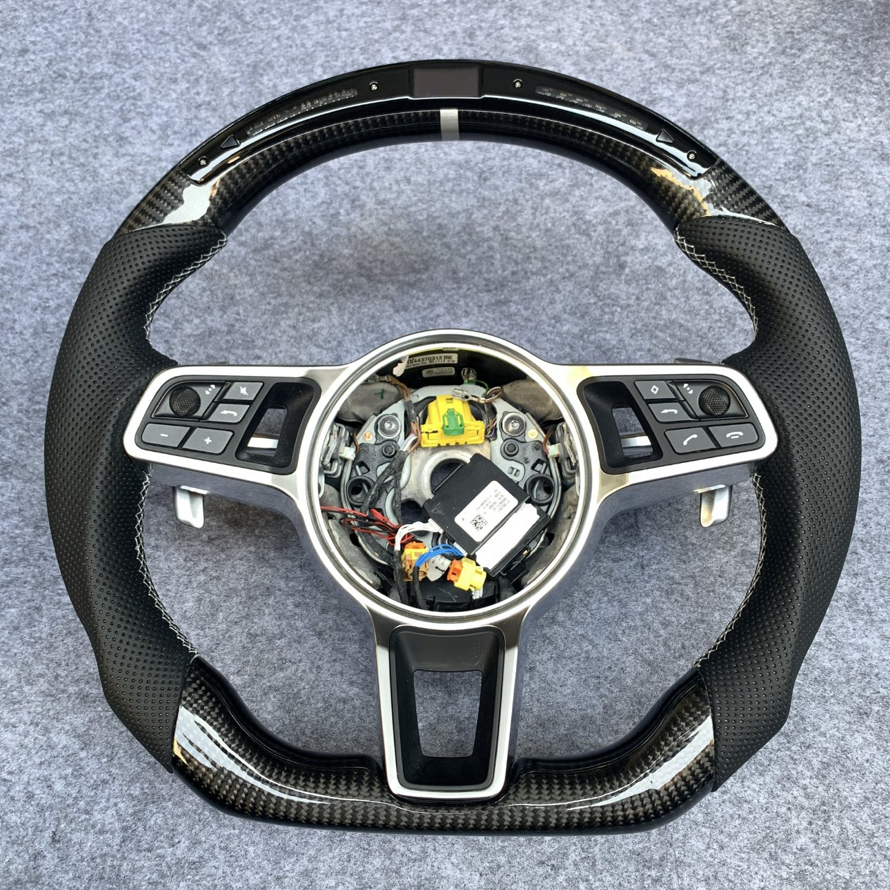 Porsche 991 and 718 custom gloss carbon fiber steering wheel with black perforated leather and LED shift display by Miami Carbon Designs