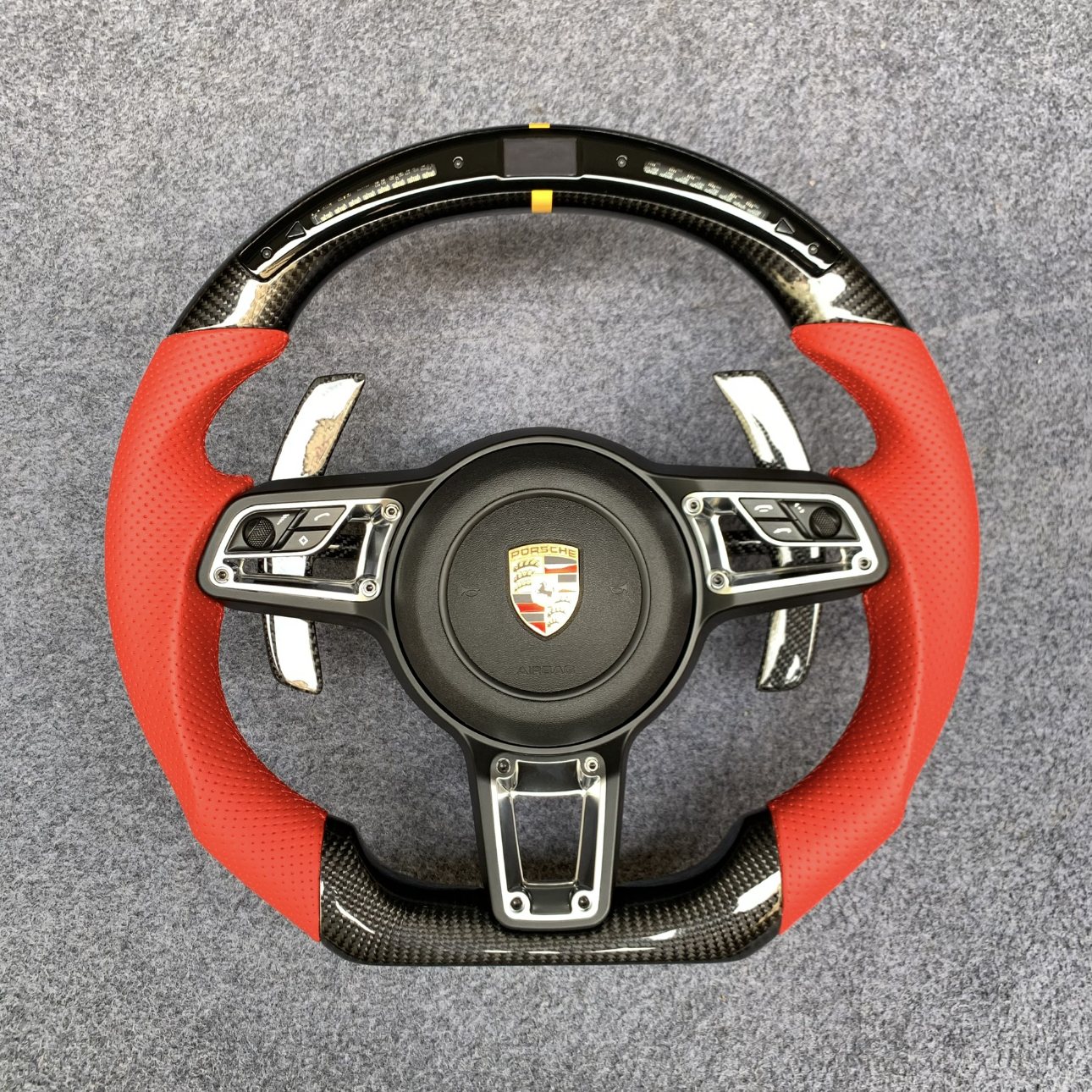 Porsche 991 and 718 custom carbon fiber steering wheel in red perforated leather with LED shift display by Miami Carbon Designs