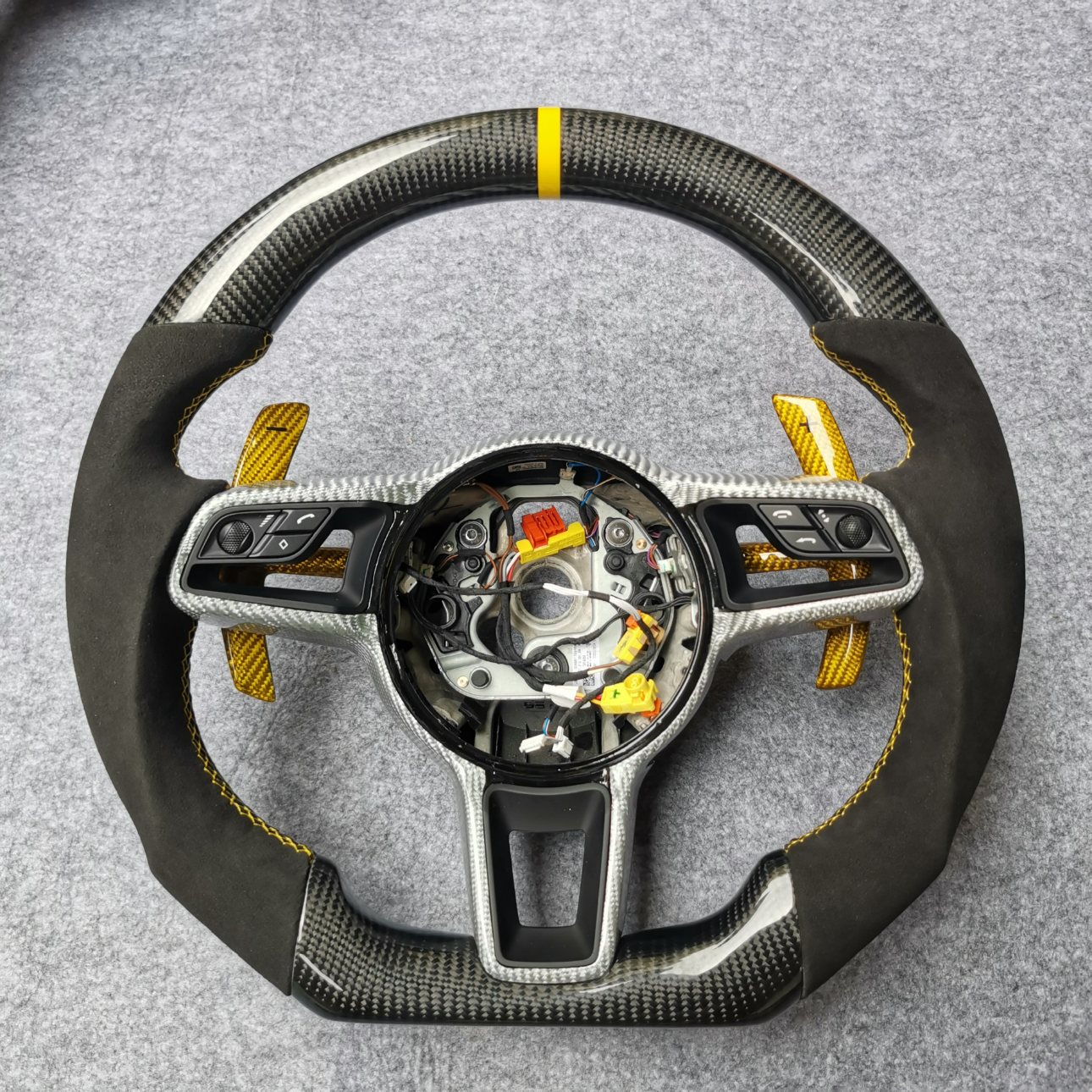 Porsche 991 custom gloss carbon fiber steering wheel with black Alcantara, yellow centerline, gold paddles and silver carbon trim by Miami Carbon Designs