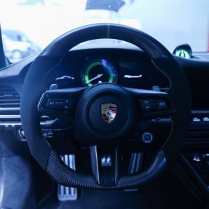 Porsche 992 Carrera T custom carbon fiber and Alcantara steering wheel with green centerline and green stitching, installed, by Miami Carbon Designs