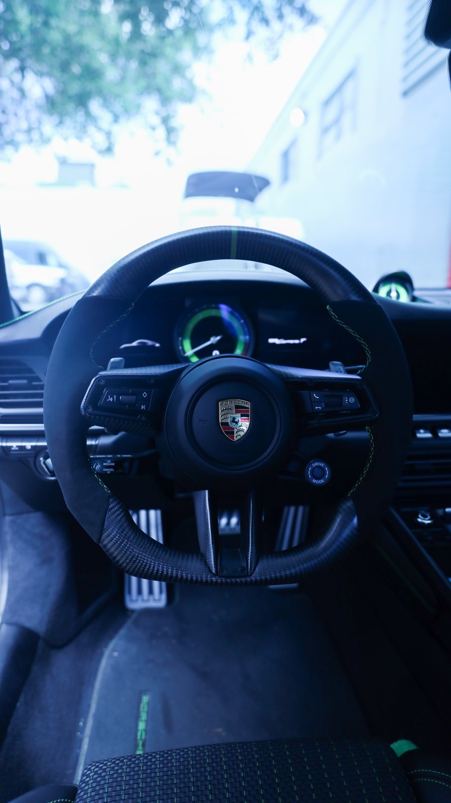 Porsche 992 Carrera T custom carbon fiber and Alcantara steering wheel with green centerline and green stitching, installed, by Miami Carbon Designs