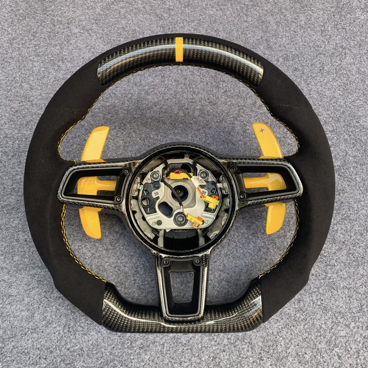 Porsche 992 custom gloss carbon fiber steering wheel with black Alcantara, yellow centerline and yellow paddle shifters by Miami Carbon Designs