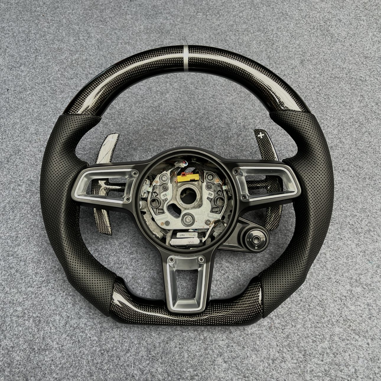 Porsche 992 custom gloss carbon fiber steering wheel with black perforated leather, silver centerline and carbon paddles by Miami Carbon Designs