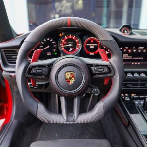 Porsche 992 911 custom matte carbon fiber steering wheel with black leather, red centerline and red carbon paddles, installed, by Miami Carbon Designs