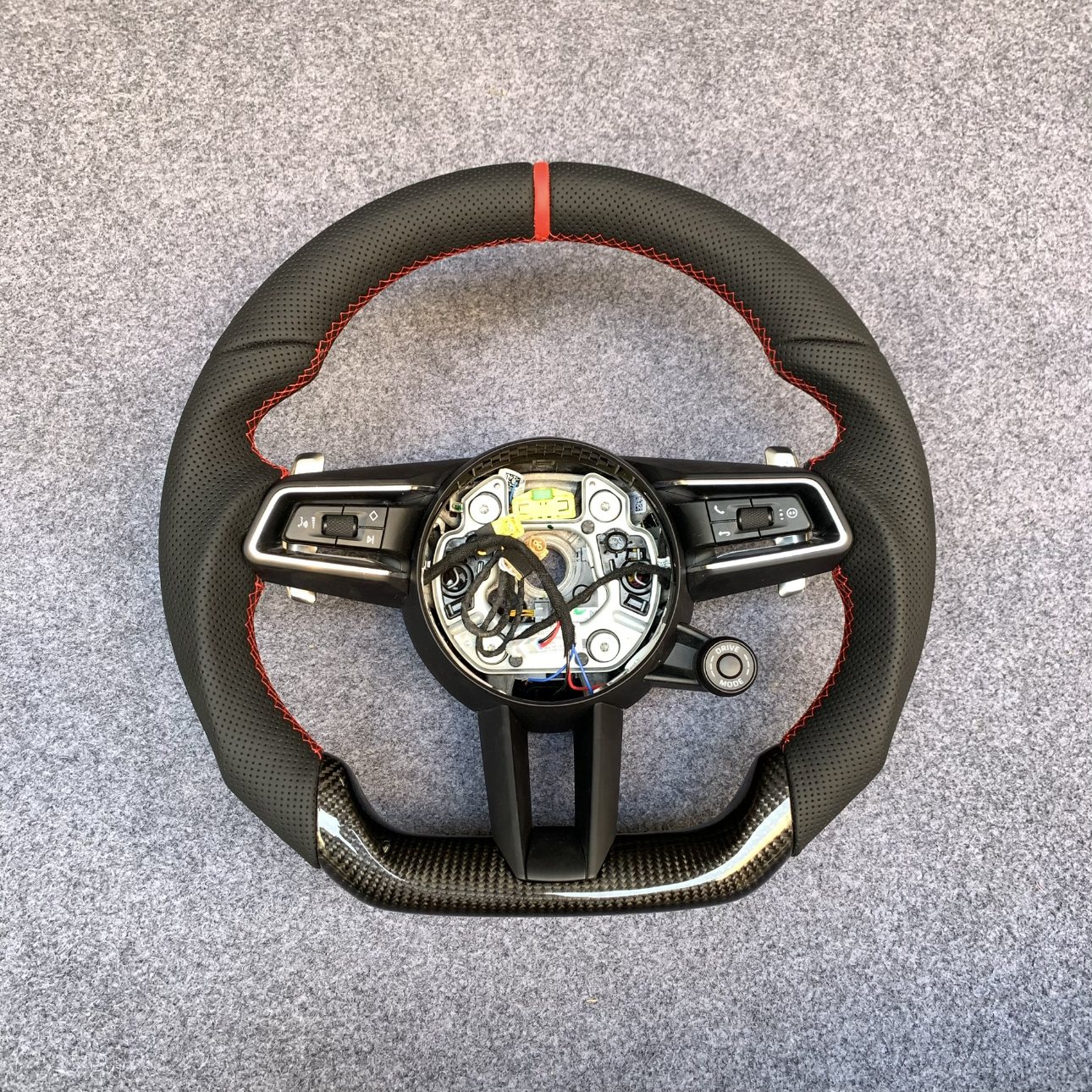 Porsche 992 custom steering wheel in black perforated leather with red centerline and gloss carbon fiber bottom by Miami Carbon Designs