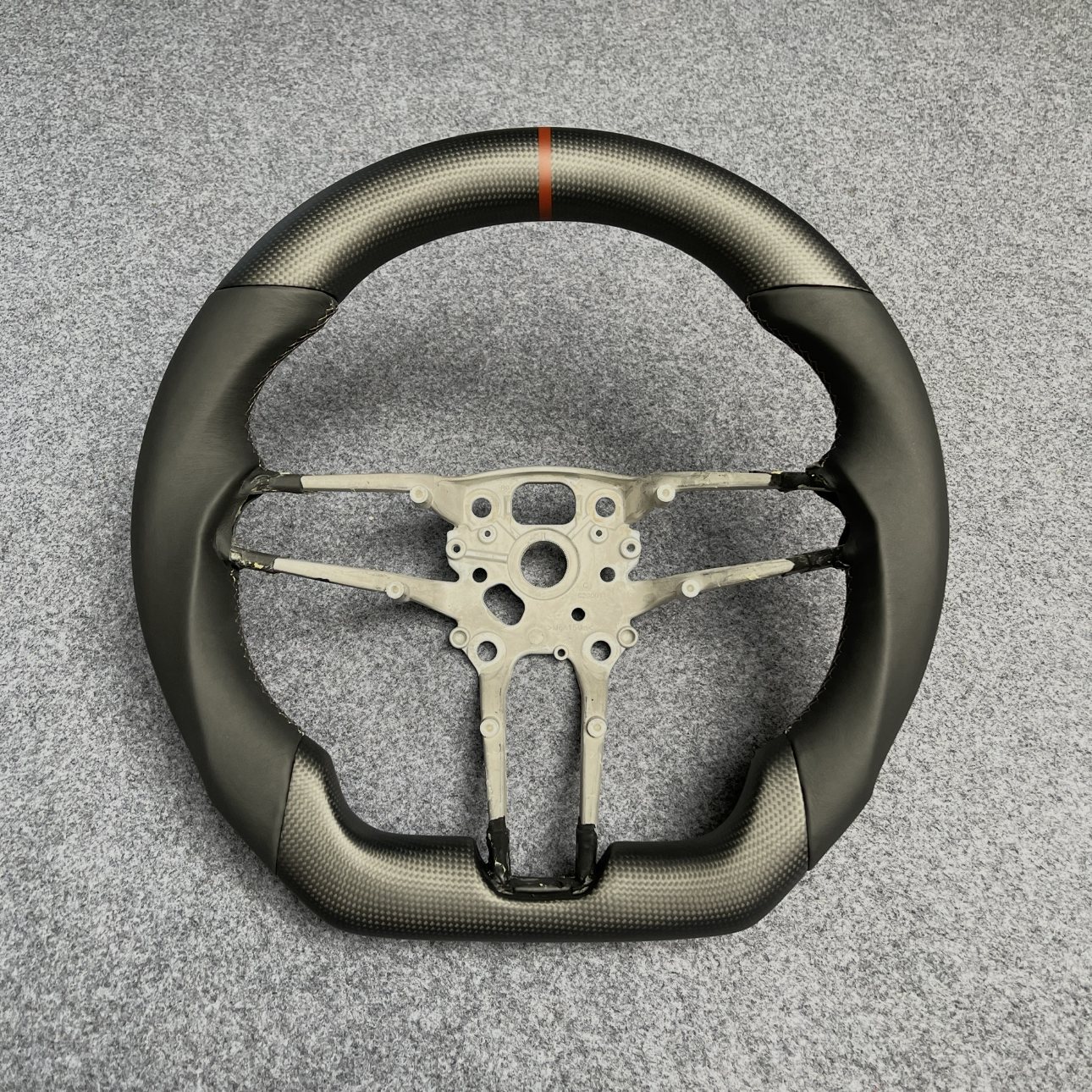 Porsche custom matte carbon fiber steering wheel with black leather and orange centerline by Miami Carbon Designs