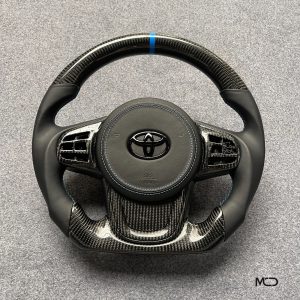 Toyota GR Supra custom carbon fiber steering wheel, black leather, blue stitching, blue stripe, leather airbag cover, gloss carbon