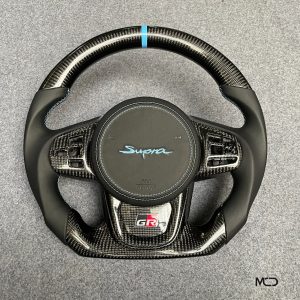 Toyota GR Supra custom carbon fiber steering wheel, black leather, blue stitching, blue stripe, airbag cover with blue Supra logo
